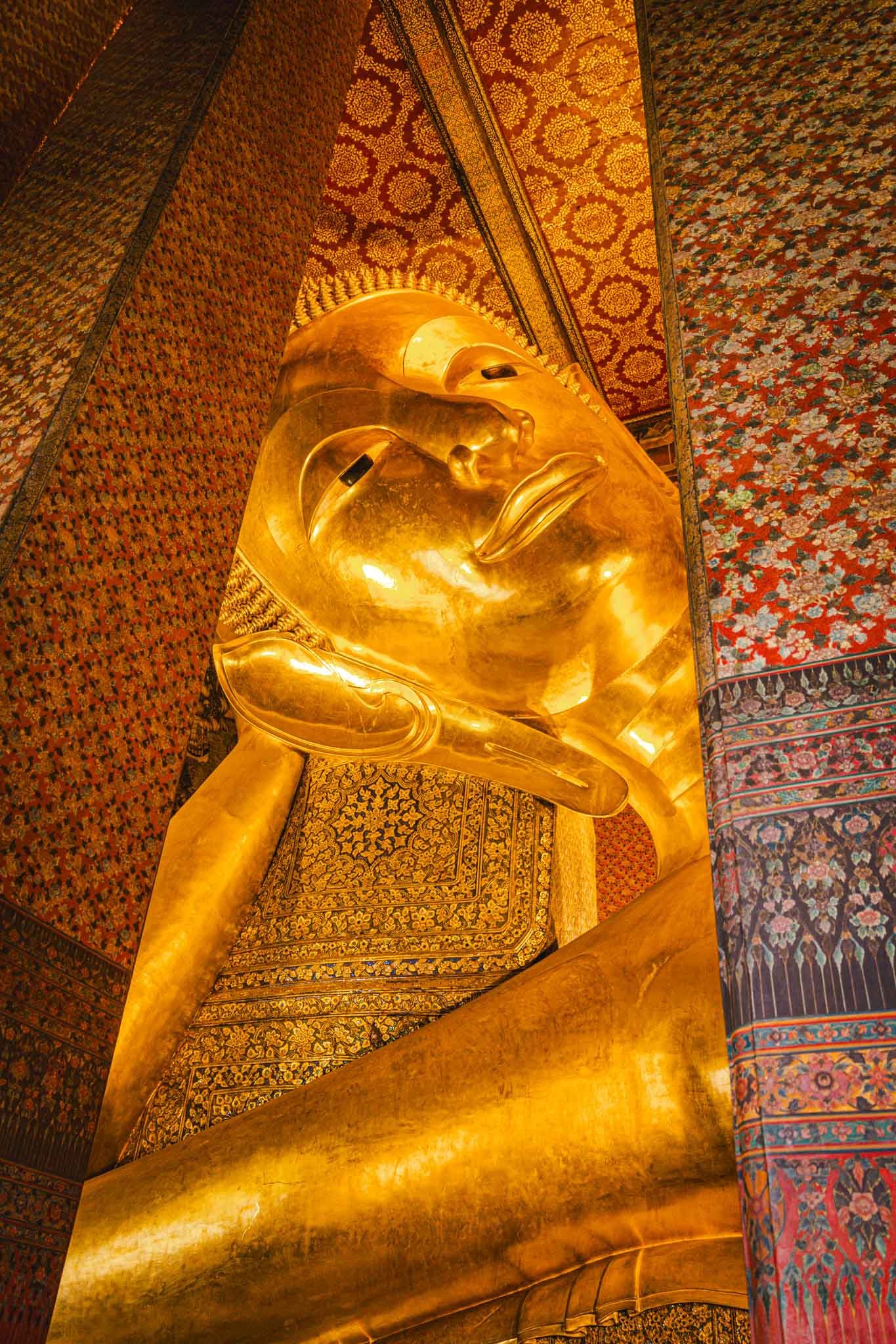 The Reclining Buddha in Bangkok, Thailand Full - Yati Travel A majestic golden statue of the Reclining Buddha in Bangkok, Thailand, symbolizing peace and enlightenment. Bangkok Travel Guide. Must-Visit Temples in Bangkok.