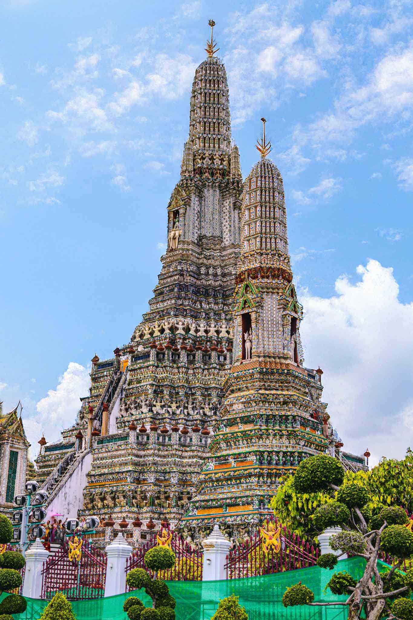 View of Wat Arun (Temple of Dawn) in Bangkok, Thailand Full - Yati Travel Wat Arun (Temple of Dawn) in Bangkok, Thailand covered in colorful porcelain. Must-Visit Temples in Bangkok.