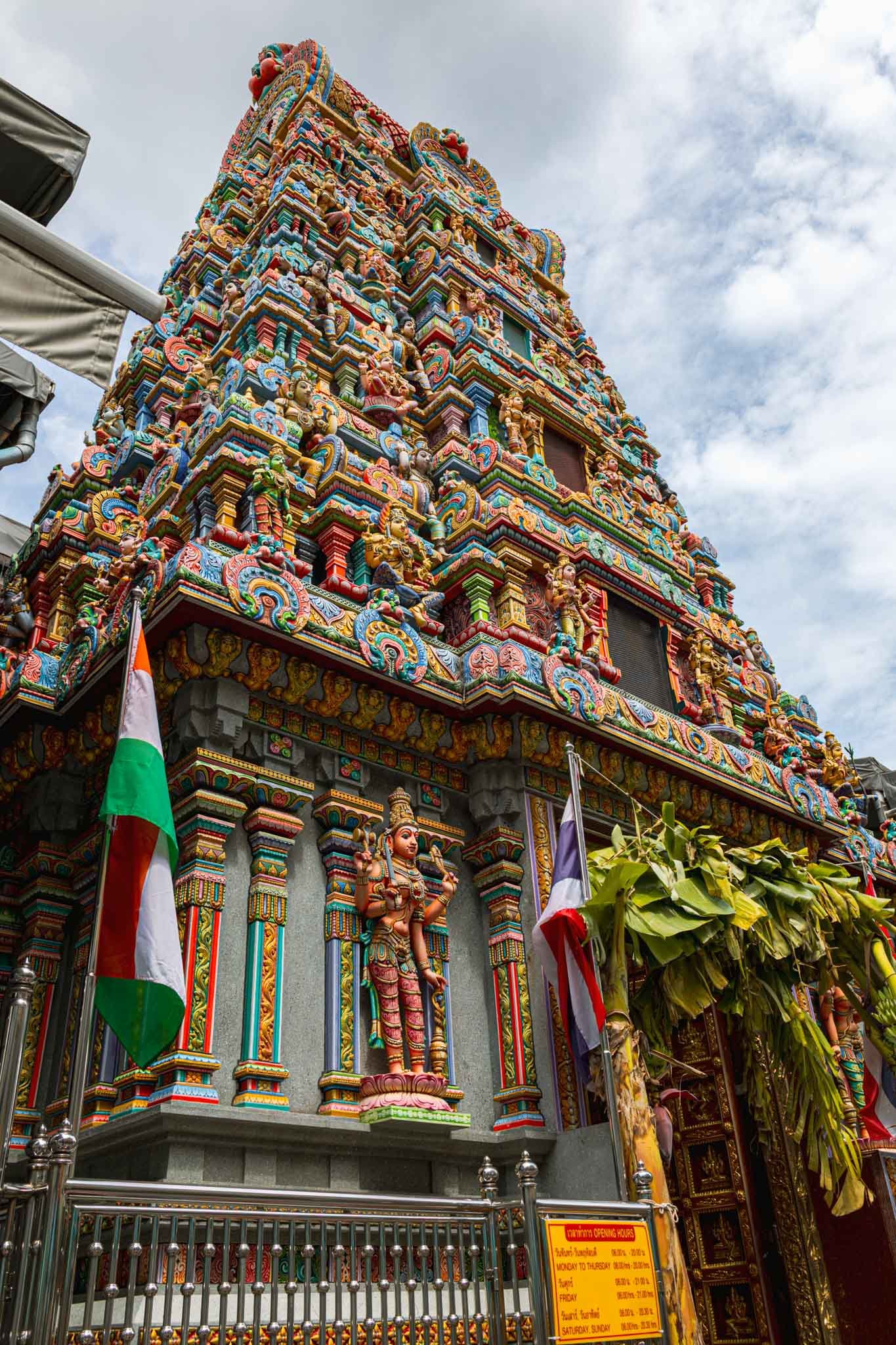 View of Wat Khaek (Sri Maha Mariamman Temple) in Bangkok, Thailand - Yati Travel Colorful Sri Maha Mariamman Temple in Bangkok, featuring a large ornate tower against a clear blue sky. Must-Visit Temples in Bangkok.