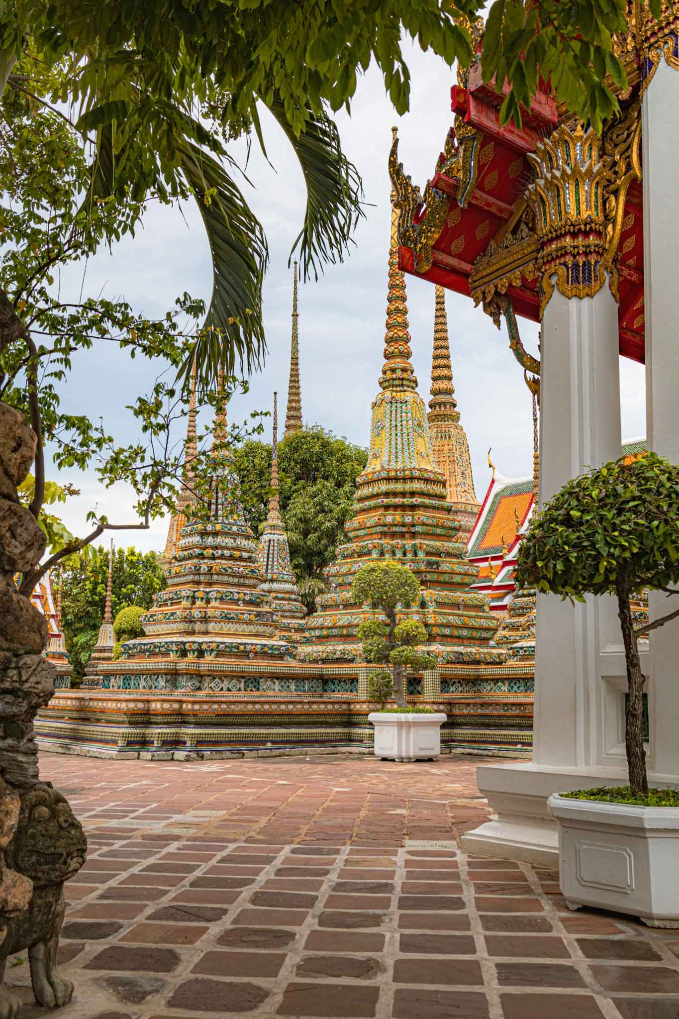 Wat Pho Temple in Bangok Thailand Full - Yati Travel Wat Pho in Bangkok Thailand, a vibrant temple with many spires, showcasing stunning architecture. Thailand Travel Guide. Must-Visit Temples in Bangkok.