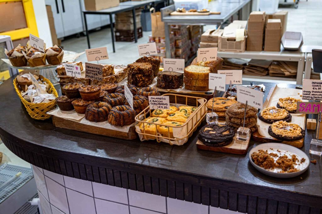 A vibrant display of cakes, muffins, and cookies at Britton's Bakery and Cakery in Amsterdam. Best Bakeries in Amsterdam.