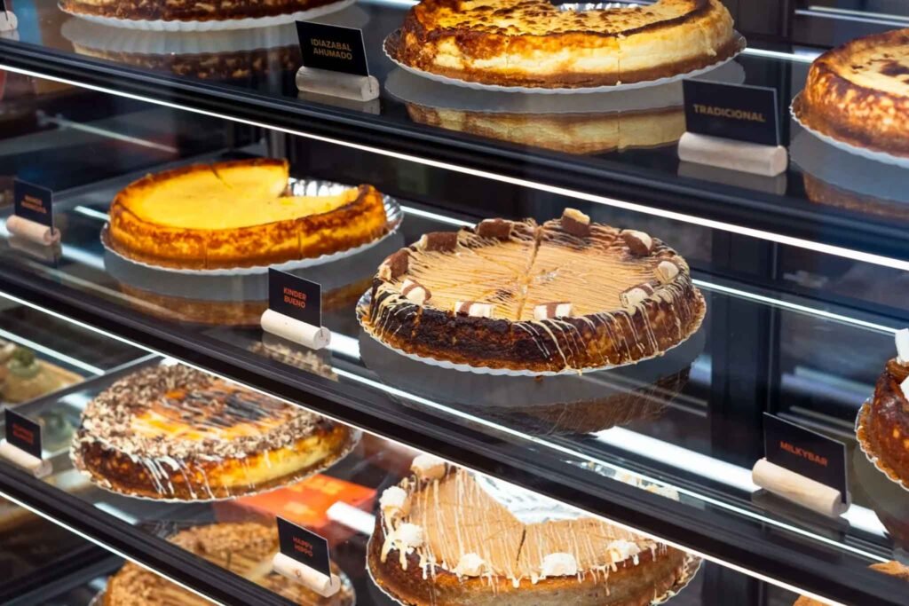 A display case at La Cheesequería in Málaga, showcasing an assortment of delicious cheesecakes, cakes, and pies. Best Places to Eat in Málaga.