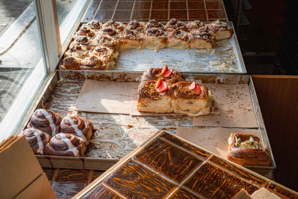 A tempting display of cinnamon buns on a table at BunBun in Amsterdam, inviting you to indulge in these pastries. Best Bakeries in Amsterdam.