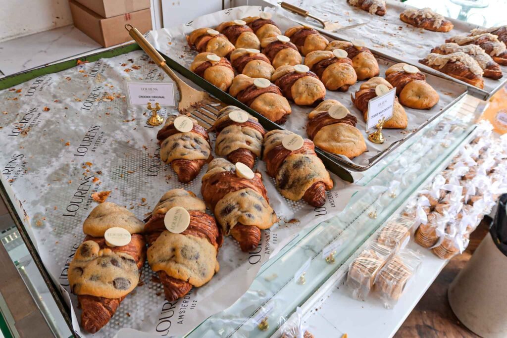 A tempting display of pastries and crookies on a counter at Lourens in Amsterdam, showcasing a variety of baked goods. Best Bakeries in Amsterdam.