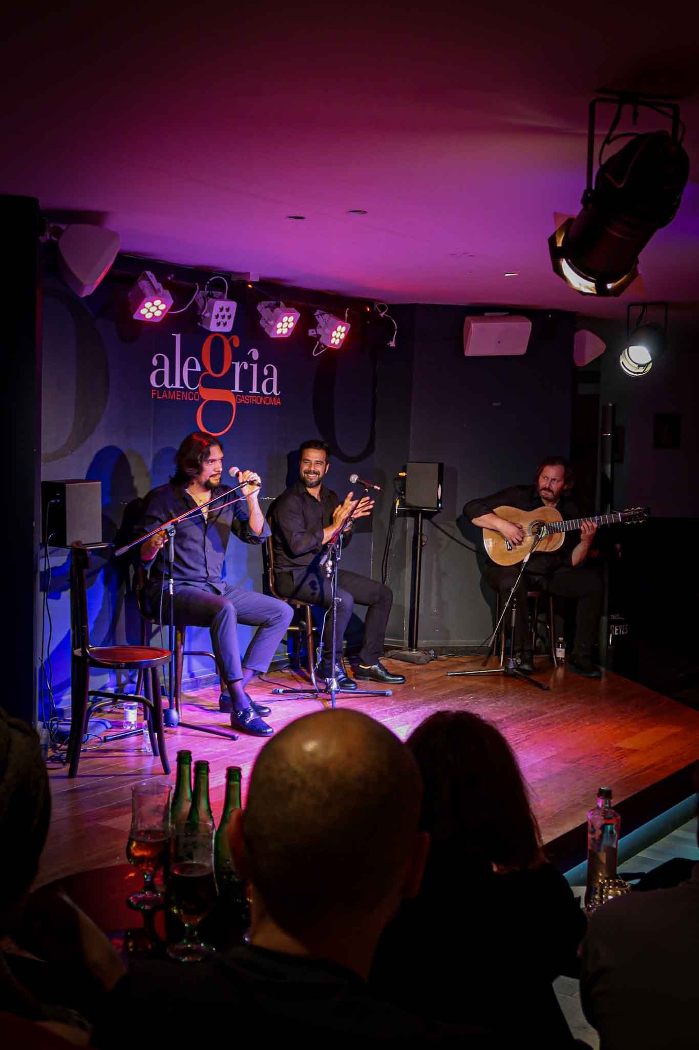 Flamenco Show at Alegría Flamenco y Gastronomía in Málaga, Spain V2 - Yati Travel Musicians play passionately on stage at the Flamenco show in Alegría Flamenco y Gastronomía, Málaga, Spain. Best Things to Do in Málaga.