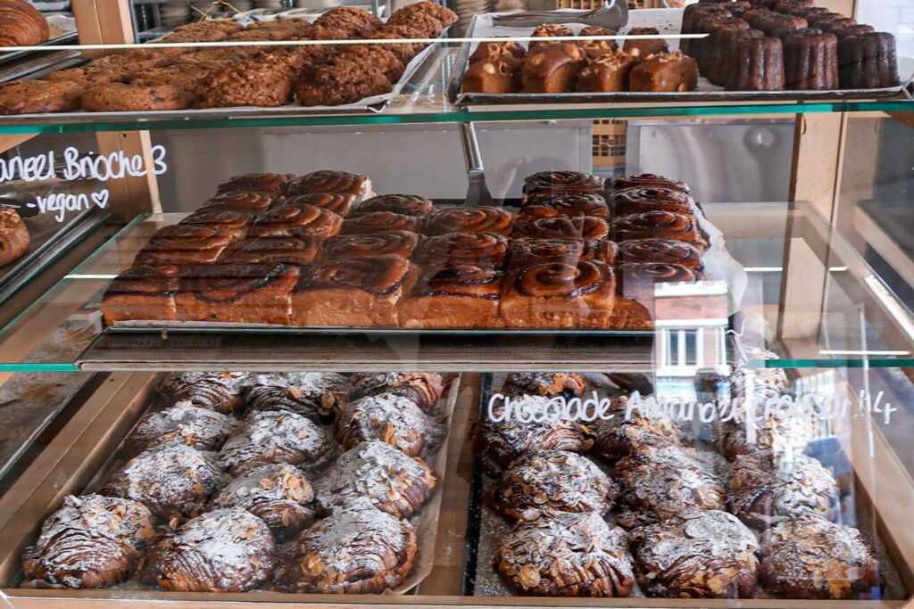 Fresh pastries displayed in a case at Fort Negen, Amsterdam, featuring an assortment of tempting baked goods. Best Bakeries in Amsterdam.