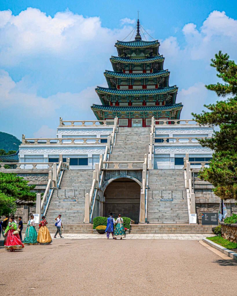 Gyeongbokgung Palace in Seoul, South-Korea - Yati Travel Visitors stroll past Gyeongbokgung Palace in Seoul, South Korea, highlighting the blend of culture and history. South-Korea Travel Guide.