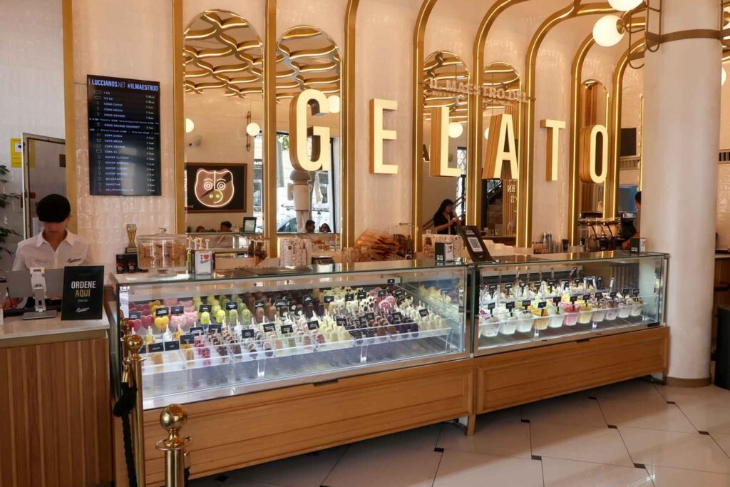 A vibrant place in Málaga, Spain, featuring a large gelato display case filled with colorful ice cream flavors. Best Places to Eat in Málaga.