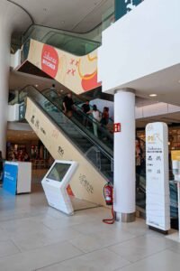 Shops and stairs inside Centro Comercial Larios Centro in Málaga, Spain, showcasing the shopping mall. Best Things to Do in Málaga.