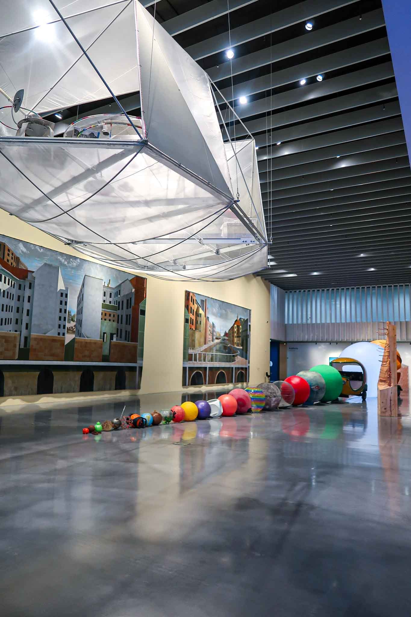 Inside of Centre Pompidou Málaga, Spain - Yati Travel A spacious room under a large white canopy, located inside the Centre Pompidou in Málaga, Spain. Best Things to Do in Málaga.
