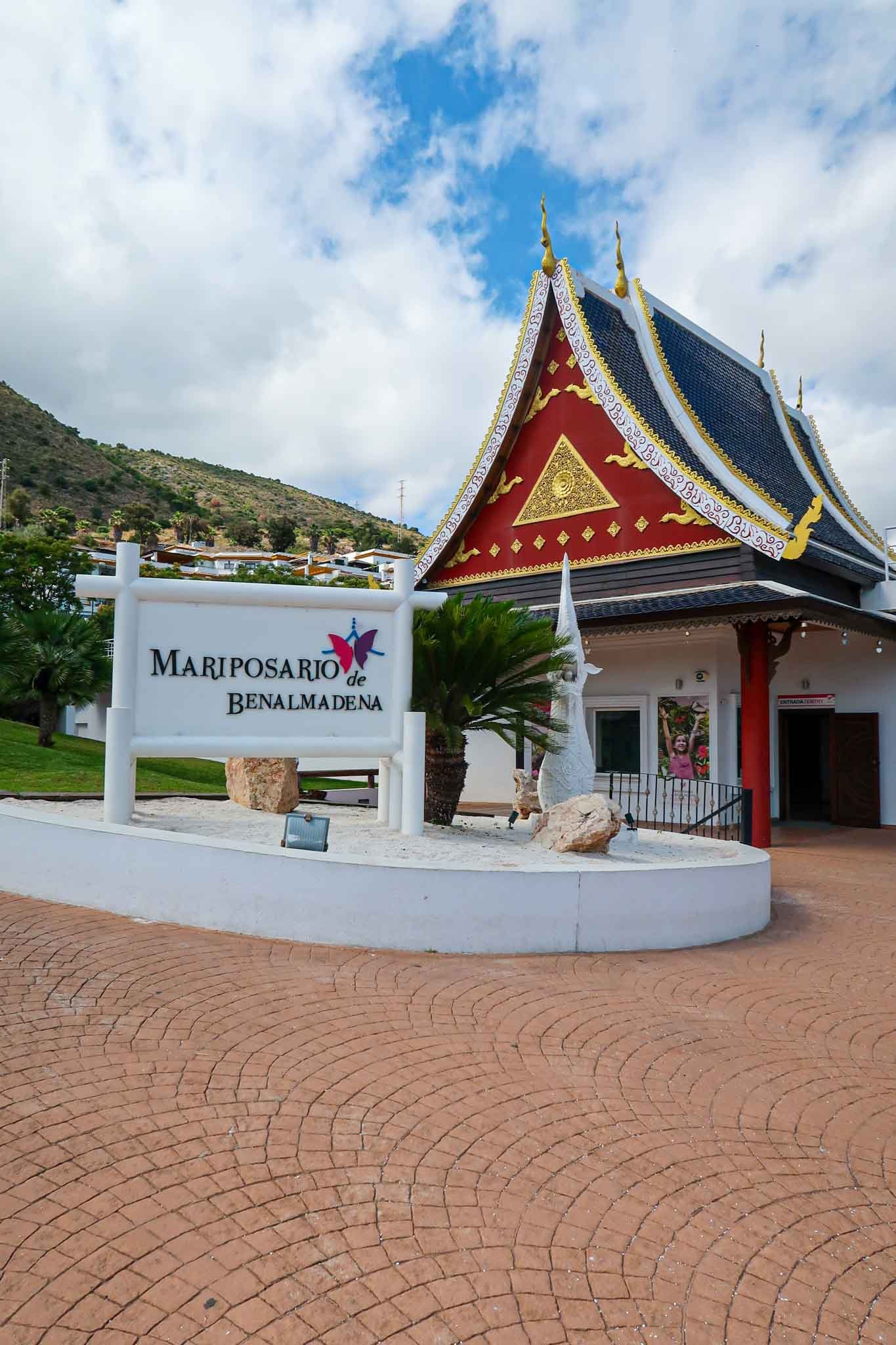 Outside Mariposario de Benalmádena (Butterfly Park) in Málaga, Spain - Yati Travel Entrance to the Pavilion at Mariposario de Benalmádena, surrounded by lush greenery in Málaga, Spain. Best Things to Do in Málaga.