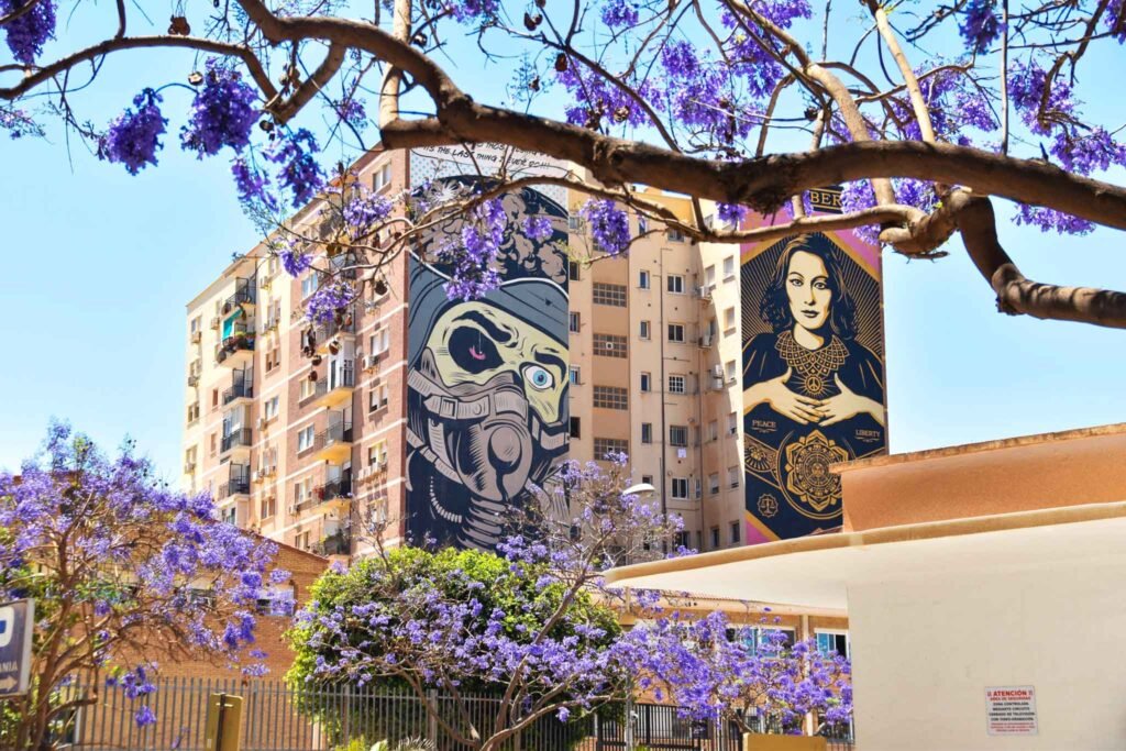 Soho District in Málaga, Spain - Yati Travel Mural depicting a woman and a man on a building in the vibrant Soho District of Málaga, Spain. Best Things to Do in Málaga.