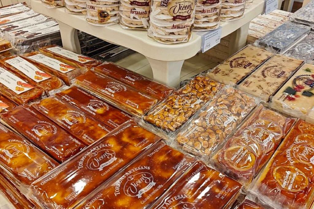 A vibrant store in Málaga, Spain, showcasing a variety of delicious foods and treats at Torrons Vicens. Best Places to Eat in Málaga.