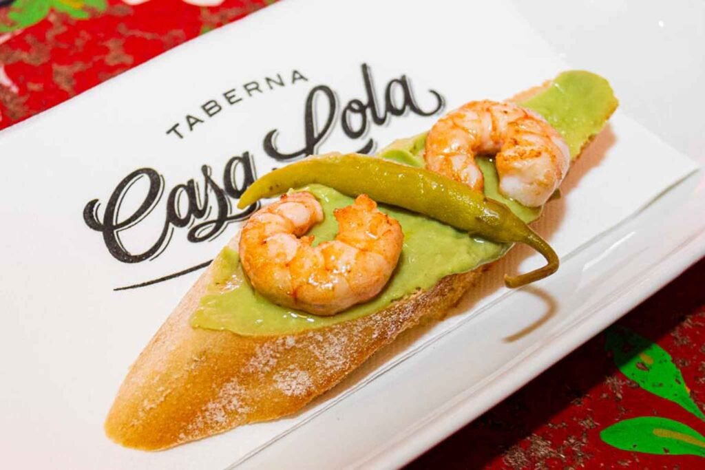Fresh Tapa guacamole with shrimp and jalapeños, prepared tableside at Casa Lola, a tapas bar in Málaga, Spain. Best Places to Eat in Málaga.