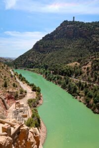 Scenic view of a river with a bridge above it, taken from Caminito del Rey in Málaga, Spain. Best Things to Do in Málaga.