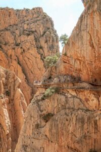A group of people walking along a scenic path in the mountains of Caminito del Rey, Málaga, Spain. Best Things to Do in Málaga.