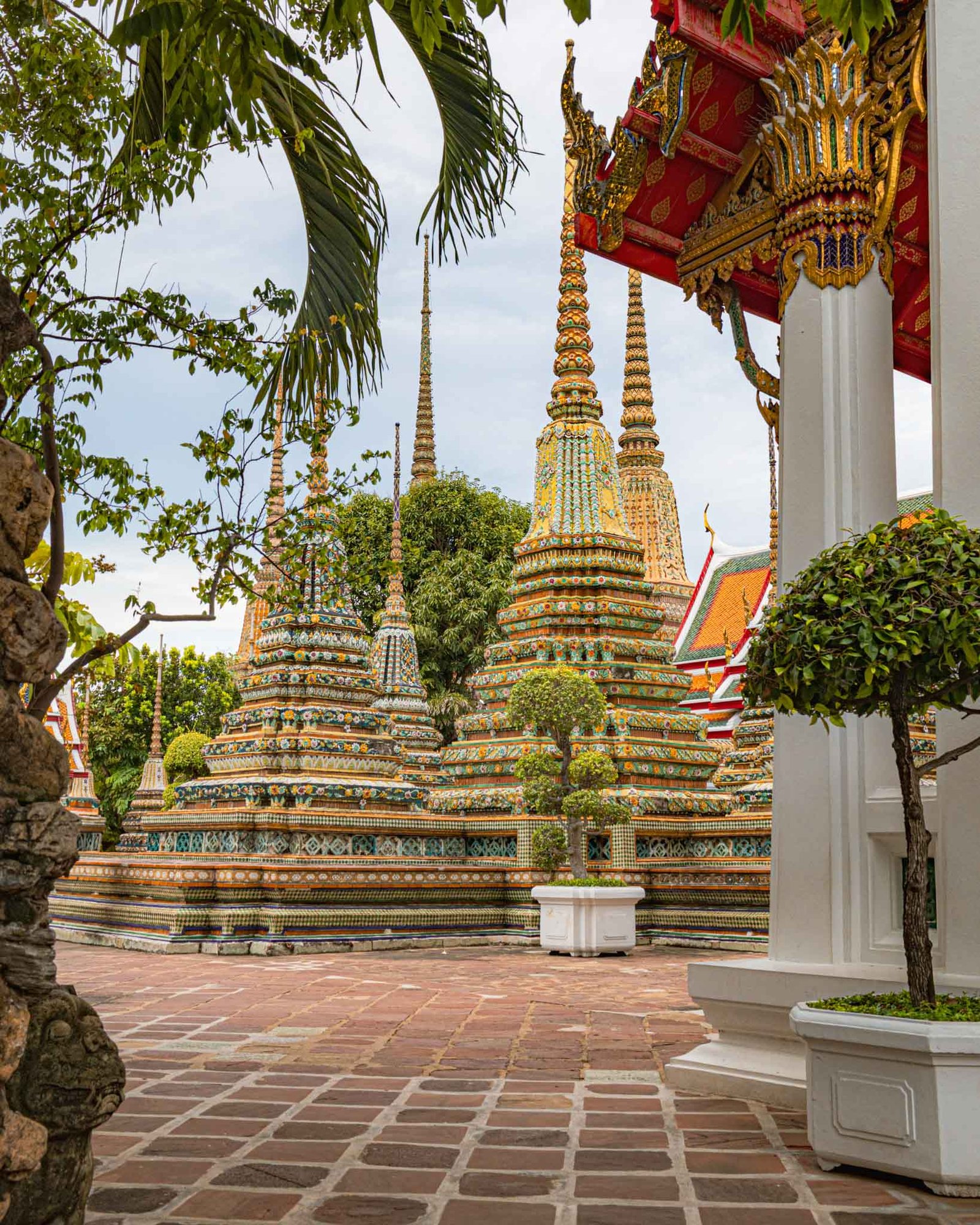Wat Pho in Bangkok Thailand, a vibrant temple with many spires, showcasing stunning architecture. A must-visit temple to add to your Thailand Travel Guide.
